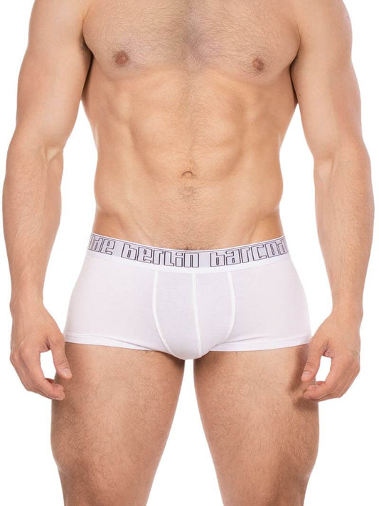 Man wearing white boxer briefs with a brand logo on the waistband against a white background