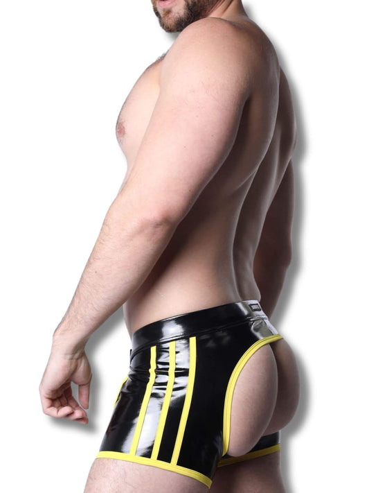 Man wearing black and yellow latex underwear against a white background