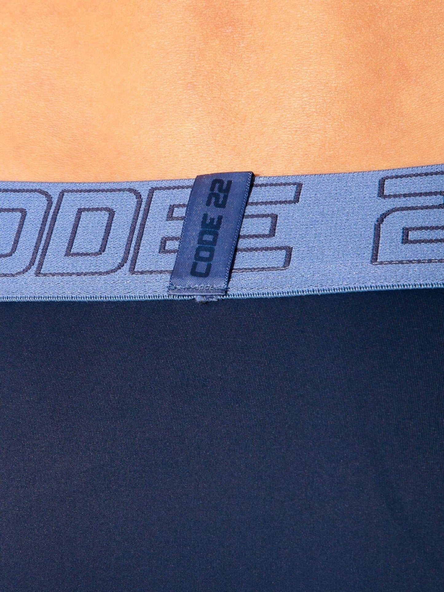 Close-up of a blue waistband with 'CODE 22' branding