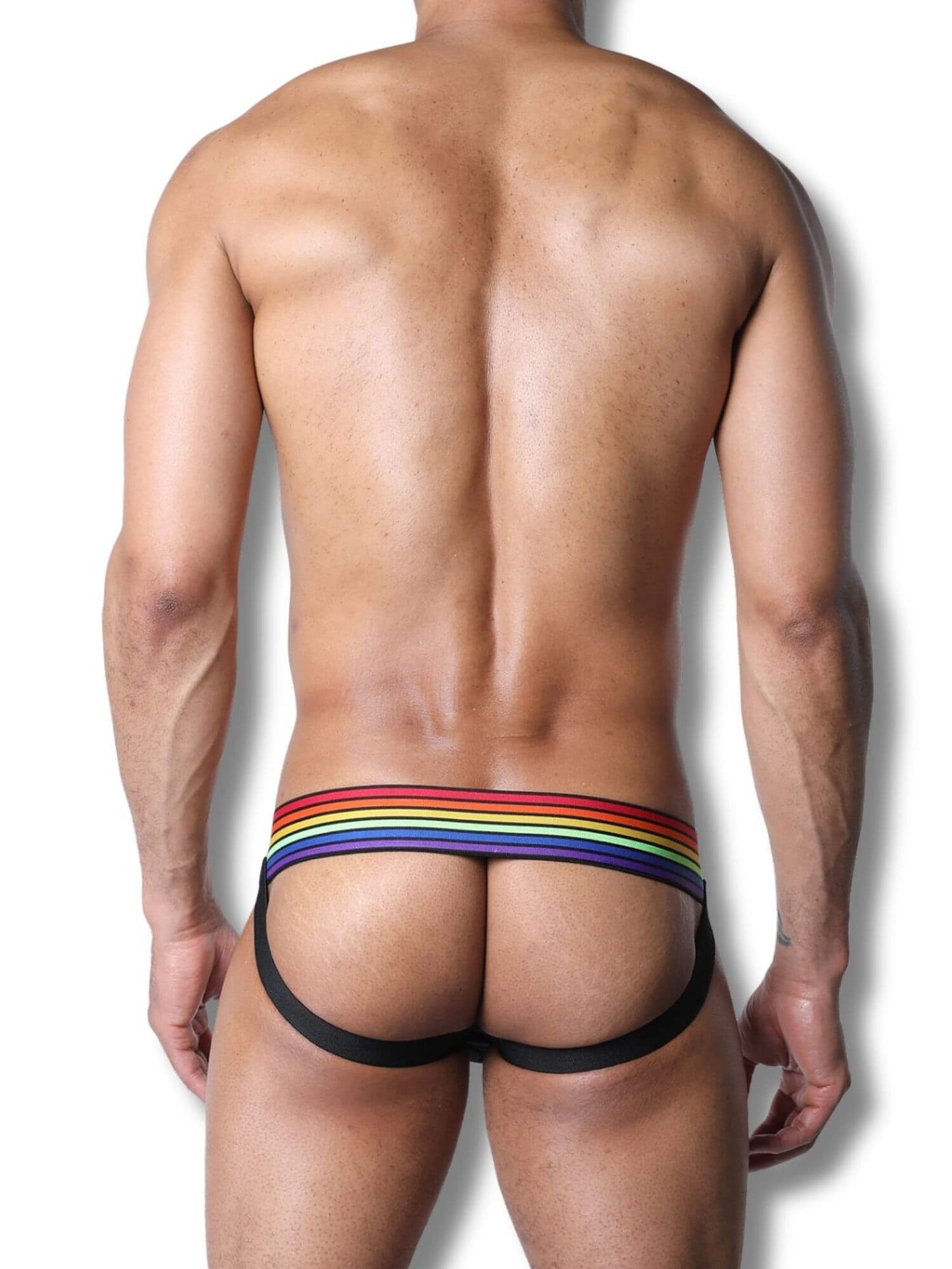 Man wearing a colorful rainbow striped underwear on a white background