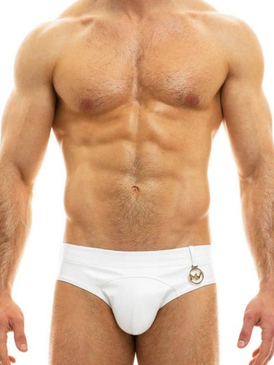 A man wearing a red leather-look brief with a low-rise waist and metallic Modus Vivendi logo.
