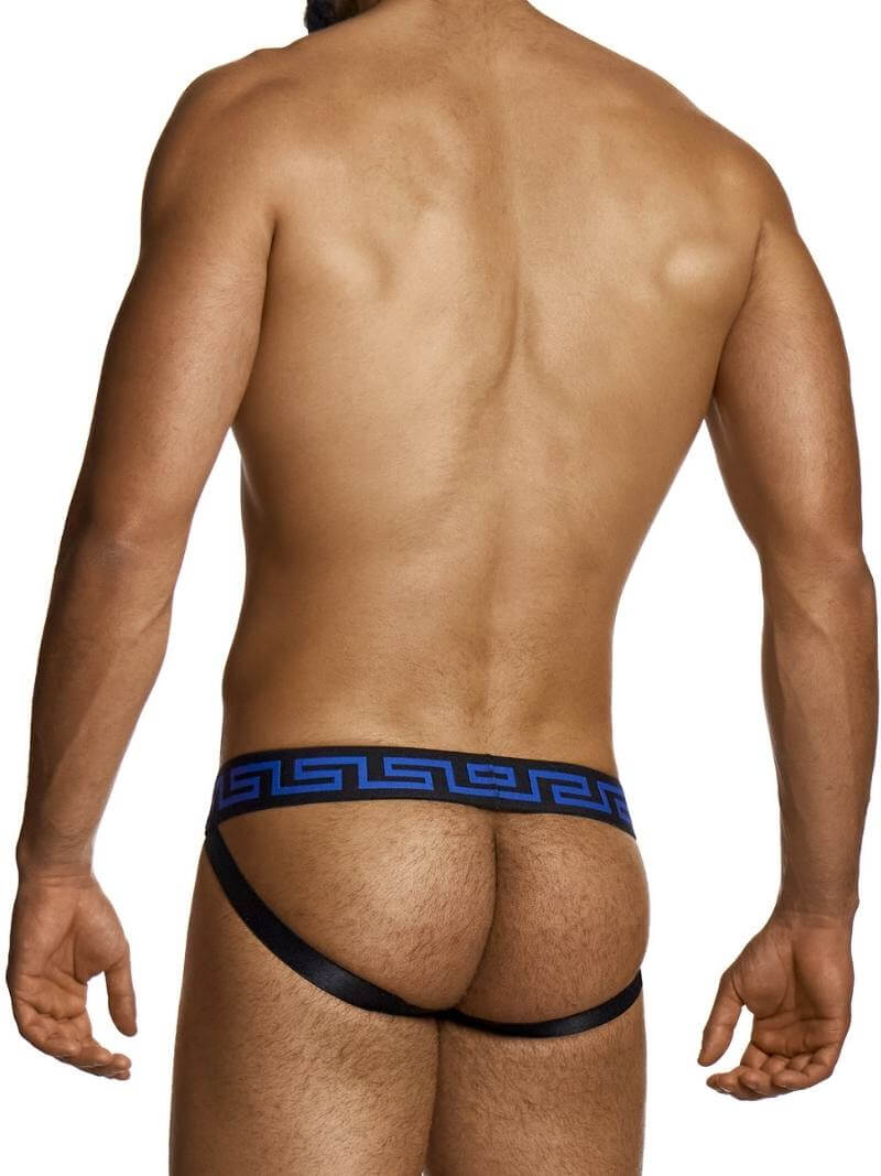 Man wearing a black thong with blue waistband on a white background