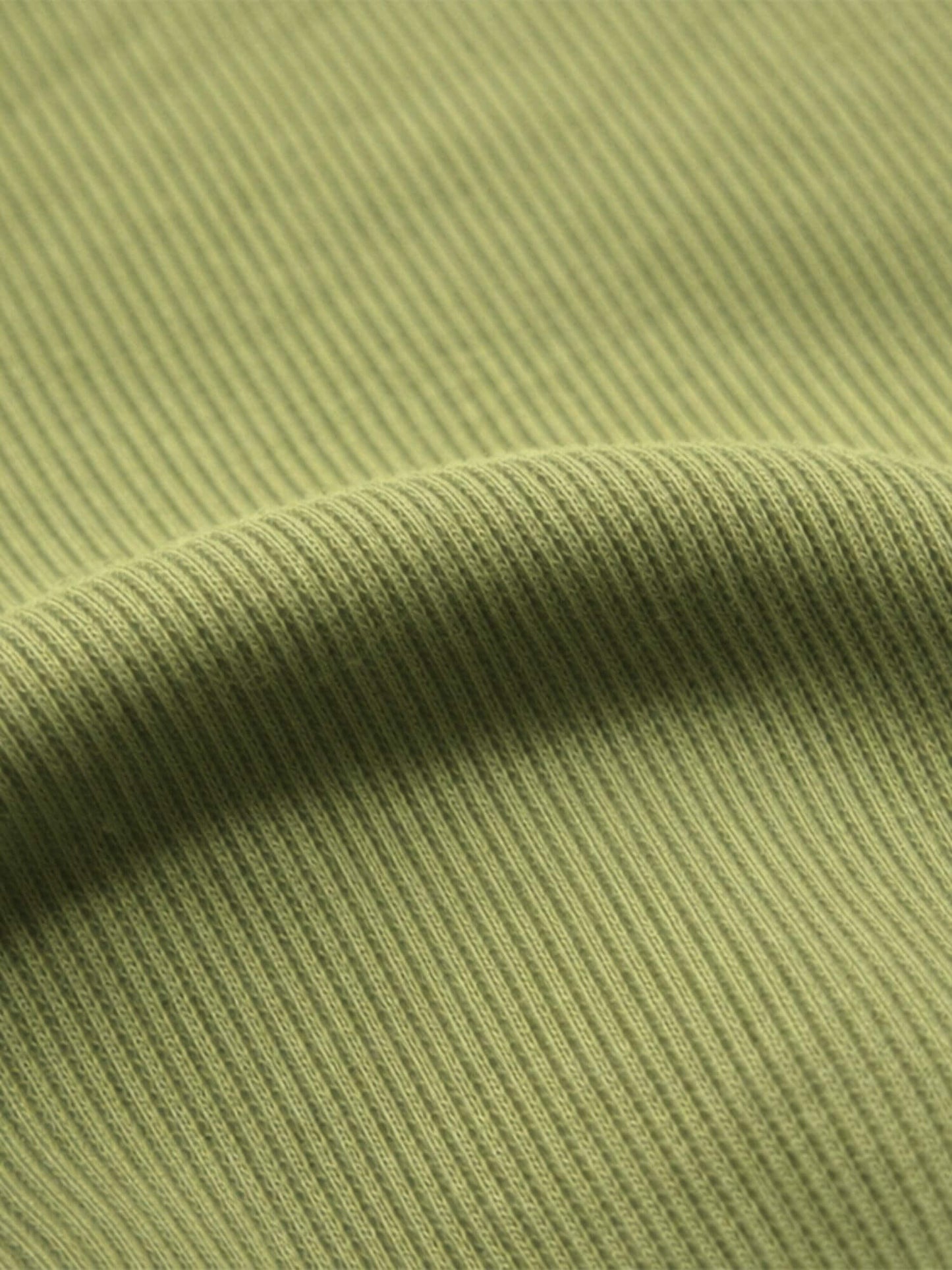 Close-up of green ribbed fabric texture