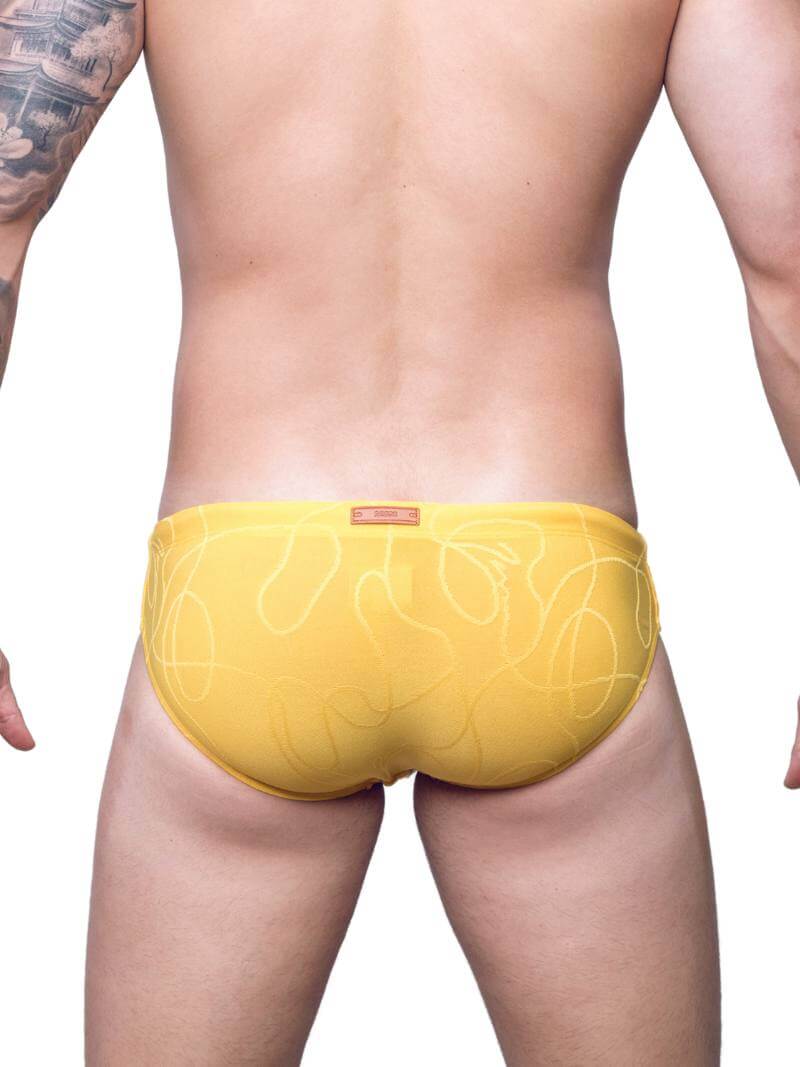 Guy Wearing 2eros V10 Textured Swim Brief in Yellow on the Beach