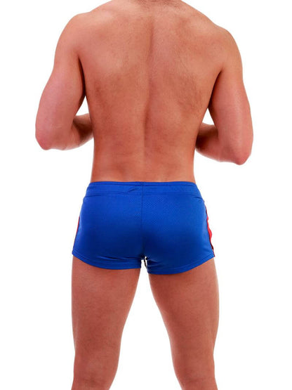 A model wearing royal blue short-legged shorts with sporty side stripes and a drawstring waist.
