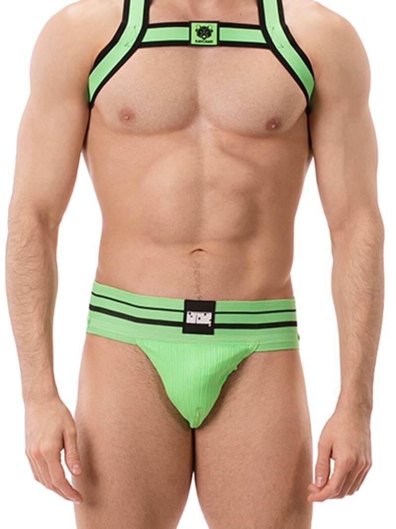 A model wearing a green BARCODE Berlin Andreus jockstrap, with the brand label visible on the striped waistband, showcasing the product's design and fit.