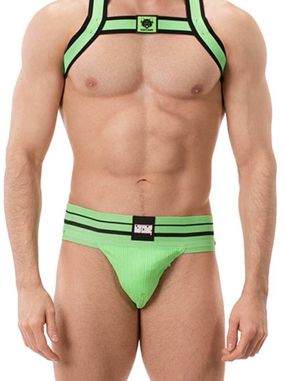 A model wearing a green BARCODE Berlin Andreus jockstrap, with the brand label visible on the striped waistband, showcasing the product's design and fit.