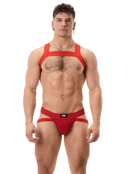 A white ribbed cotton butt lifting jockstrap by Barcode Berlin, featuring a sturdy thick waistband and elasticated jock straps, modelled by a male model.