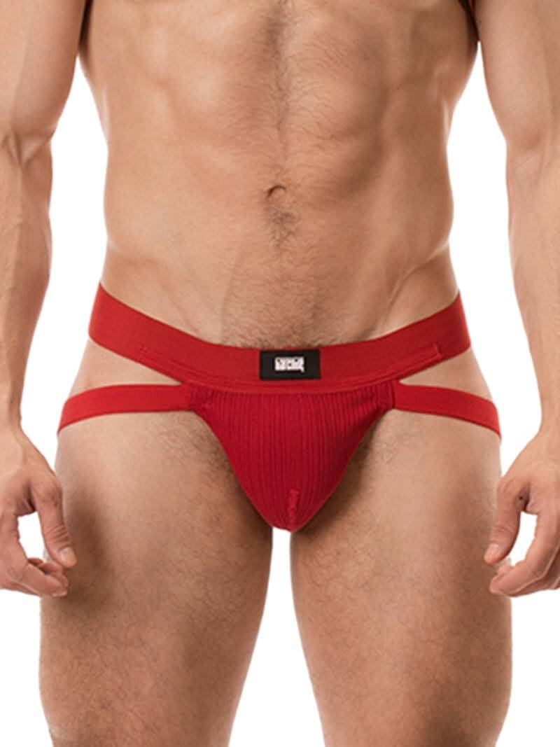 A red ribbed cotton butt lifting jockstrap by Barcode Berlin, featuring a sturdy thick waistband and elasticated jock straps, modelled by a male model.