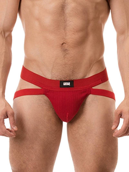 A red ribbed cotton butt lifting jockstrap by Barcode Berlin, featuring a sturdy thick waistband and elasticated jock straps, modelled by a male model.