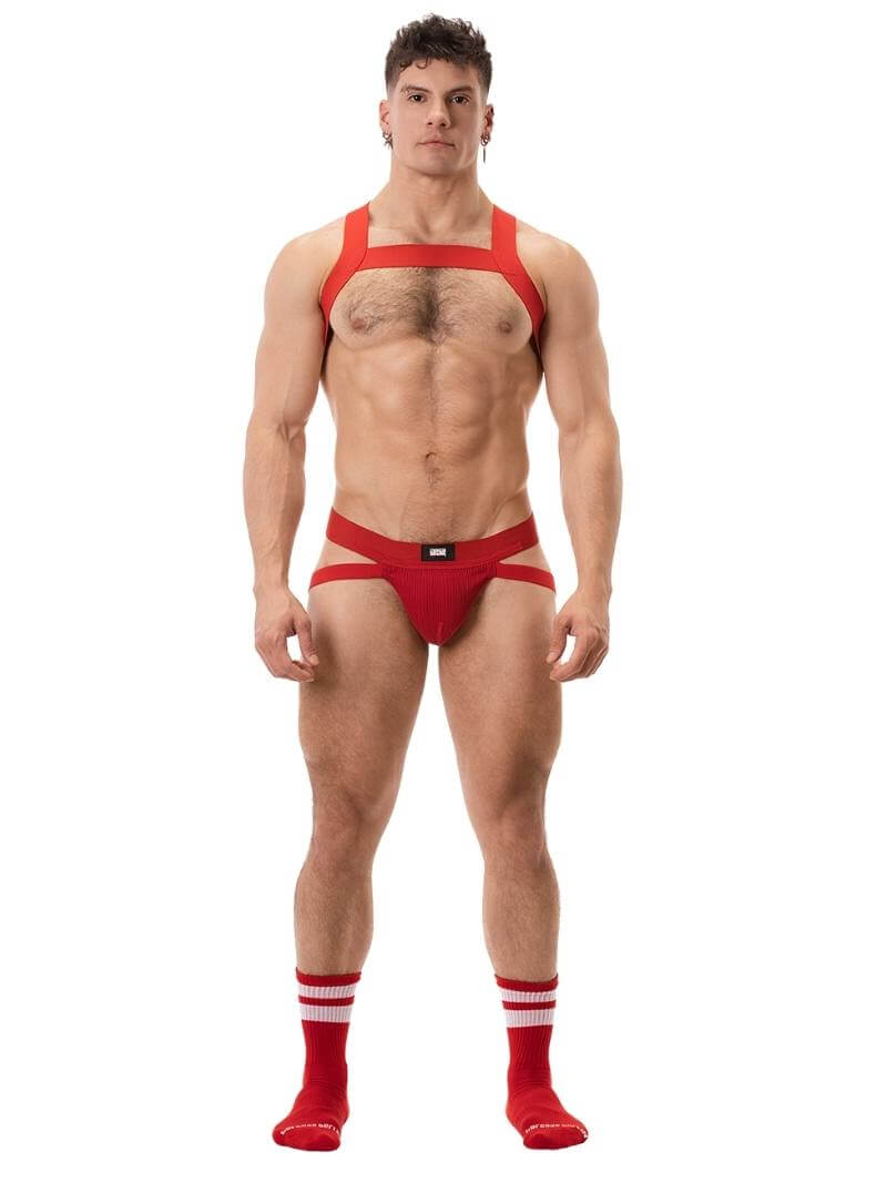 A white ribbed cotton butt lifting jockstrap by Barcode Berlin, featuring a sturdy thick waistband and elasticated jock straps, modelled by a male model.