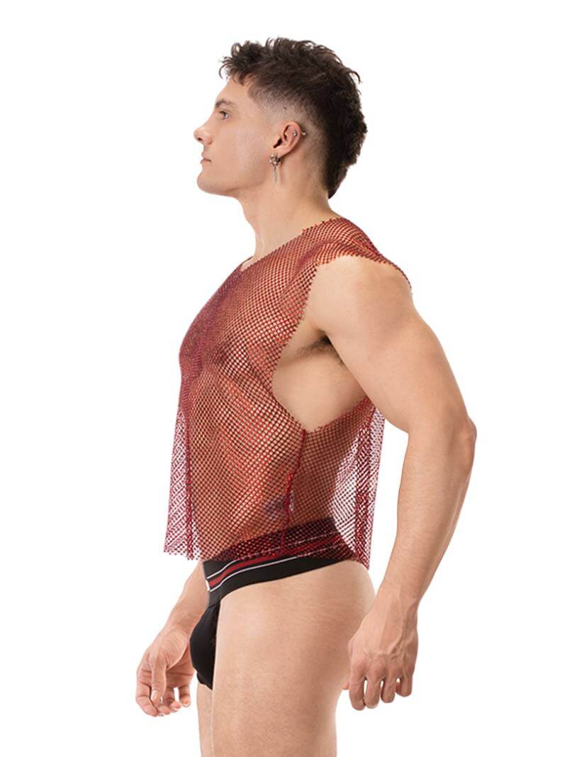 A male model wearing a sleeveless, round neck, mesh tank top in red with glitter accents, paired with black shorts with red trim. The tank top has a clubwear and partywear style, semi-see-through with a shimmering effect.