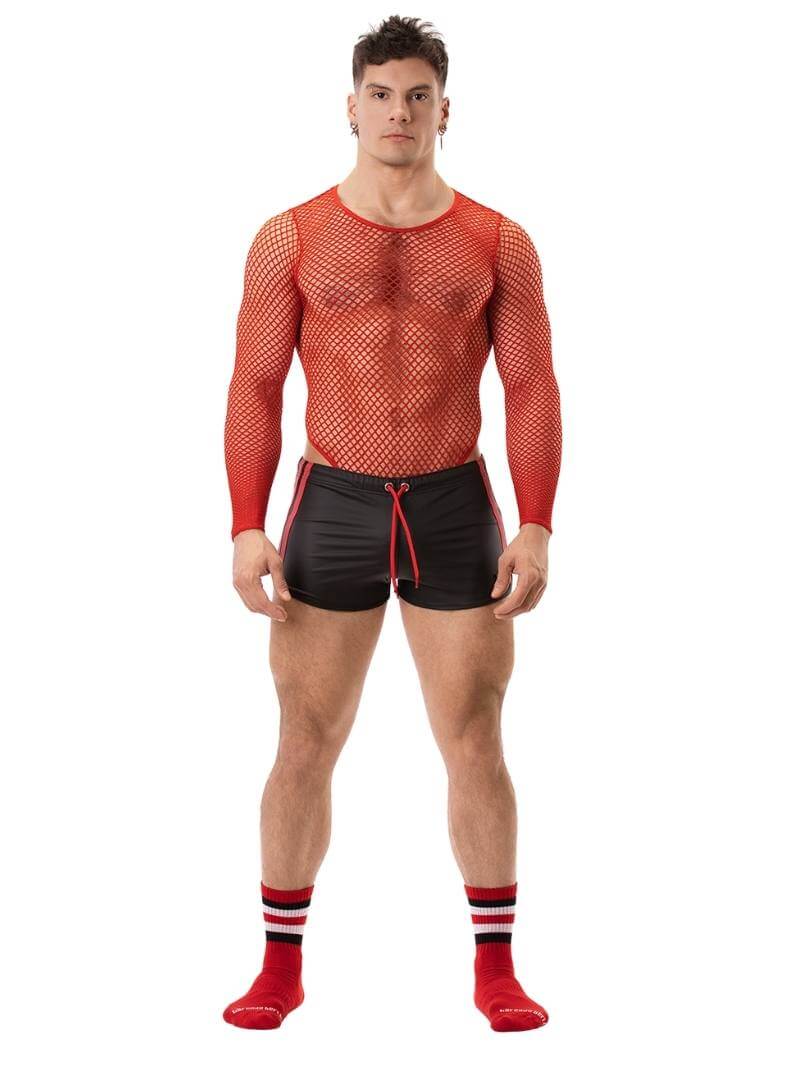 A man wearing red fishnet long-sleeve top and black mini shorts with sporty stripes and a drawstring.