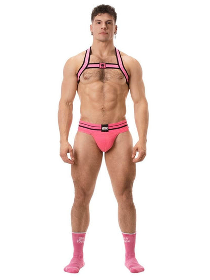 A model wearing a pink BARCODE Berlin Andreus jockstrap, with the brand label visible on the striped waistband, showcasing the product's design and fit.