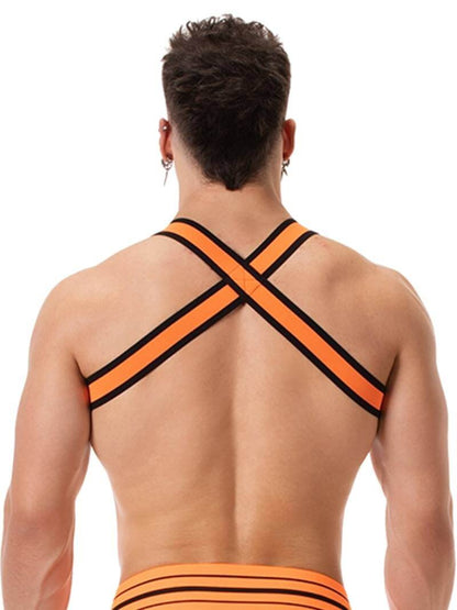 A male model wearing a neon orange and black elastic chest harness with the BARCODE Berlin brand emblem on the front horizontal strap.