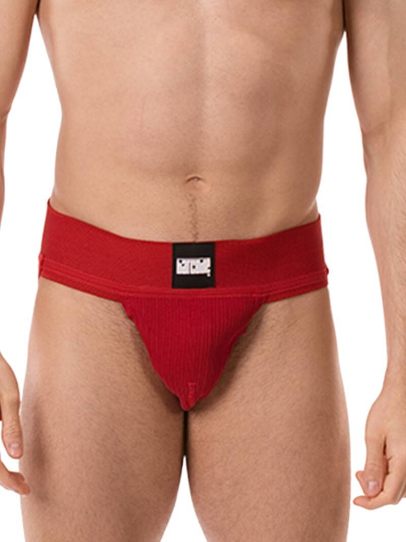A model wearing a white Barcode Berlin Sergey ribbed cotton jockstrap, with the brand label visible on the waistband.