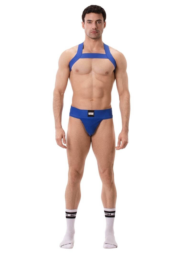 A model wearing a white Barcode Berlin Sergey ribbed cotton jockstrap, with the brand label visible on the waistband.