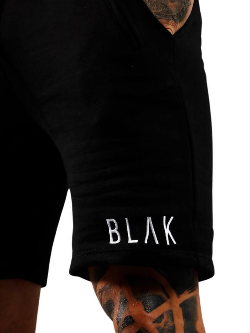 Black shorts with 'BLAK' branding on a white background