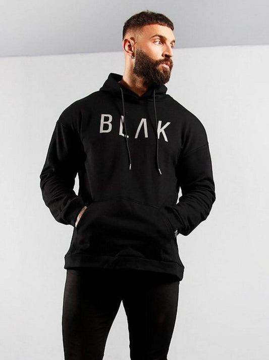 Man wearing a black hoodie with 'BLAK' logo on a light gray background