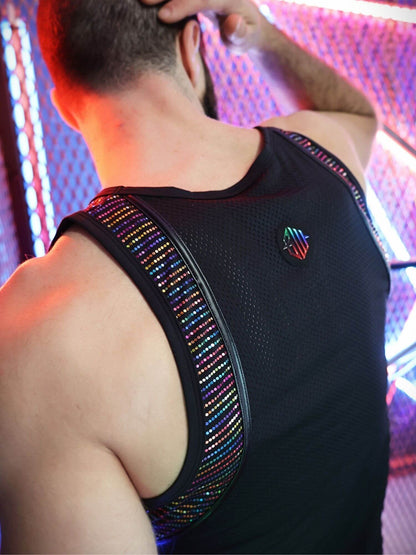 Person wearing a black tank top with a colorful back design against a blurred background