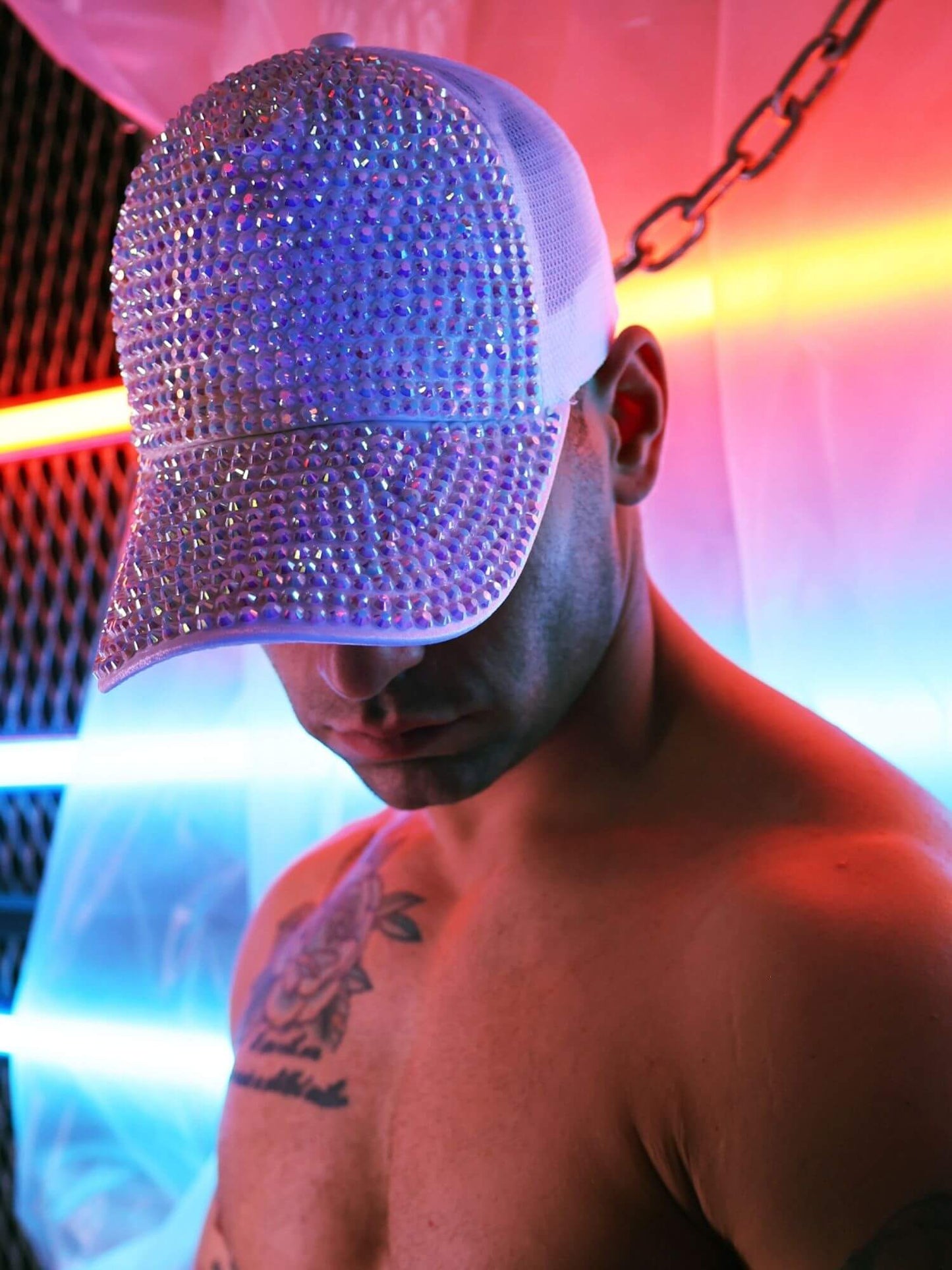 Person wearing a sparkly cap with a colorful background