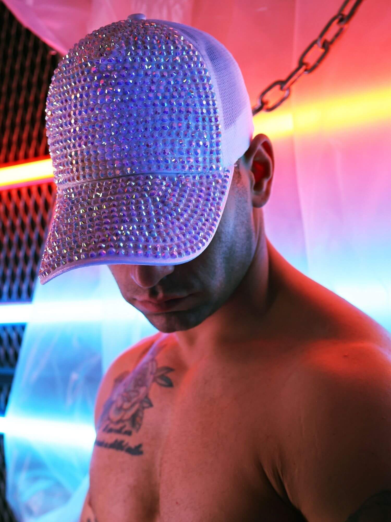 Person wearing a sparkly cap with a colorful background
