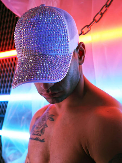 Person wearing a sparkly cap with a colorful background