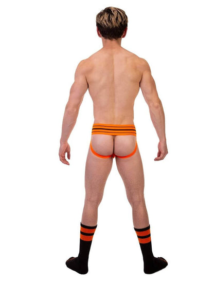 A model wearing a green BARCODE Berlin Andreus jockstrap, with the brand label visible on the striped waistband, showcasing the product's design and fit.