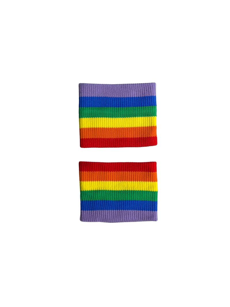 A hand holding two white wristbands with gay pride stripes