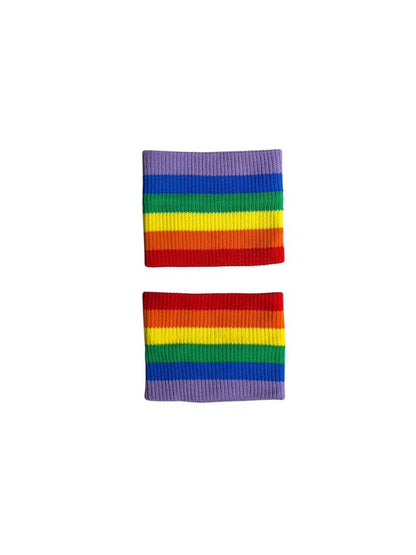 A hand holding two white wristbands with gay pride stripes