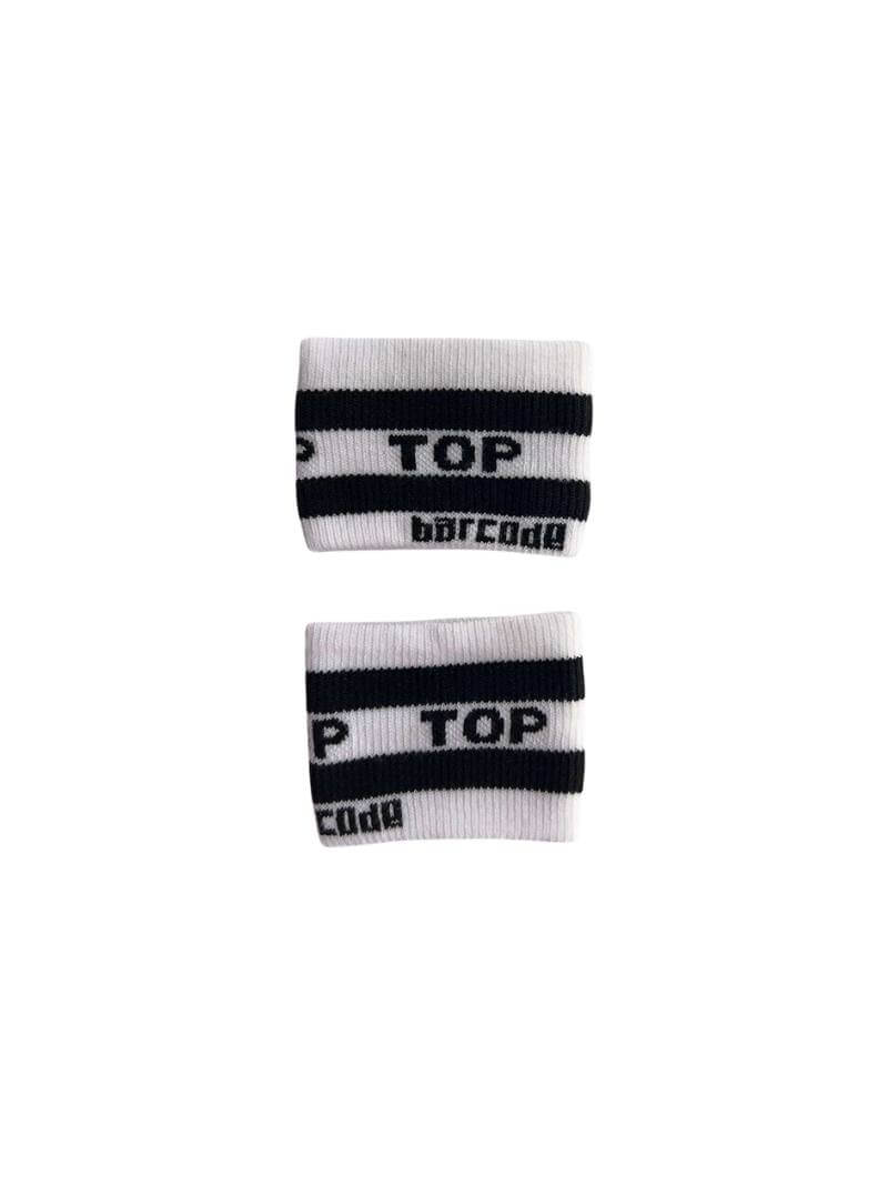 A hand holding two white wristbands with the text 'Top' written in black lettering and a black stripe design.
