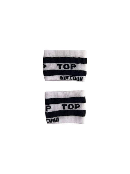 A hand holding two white wristbands with the text 'Top' written in black lettering and a black stripe design.