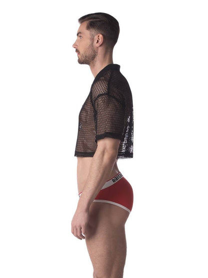 A male model wearing a black semi-see-through mesh fishnet crop top with short sleeves and a v-neck, branded with 'BARCODE'.