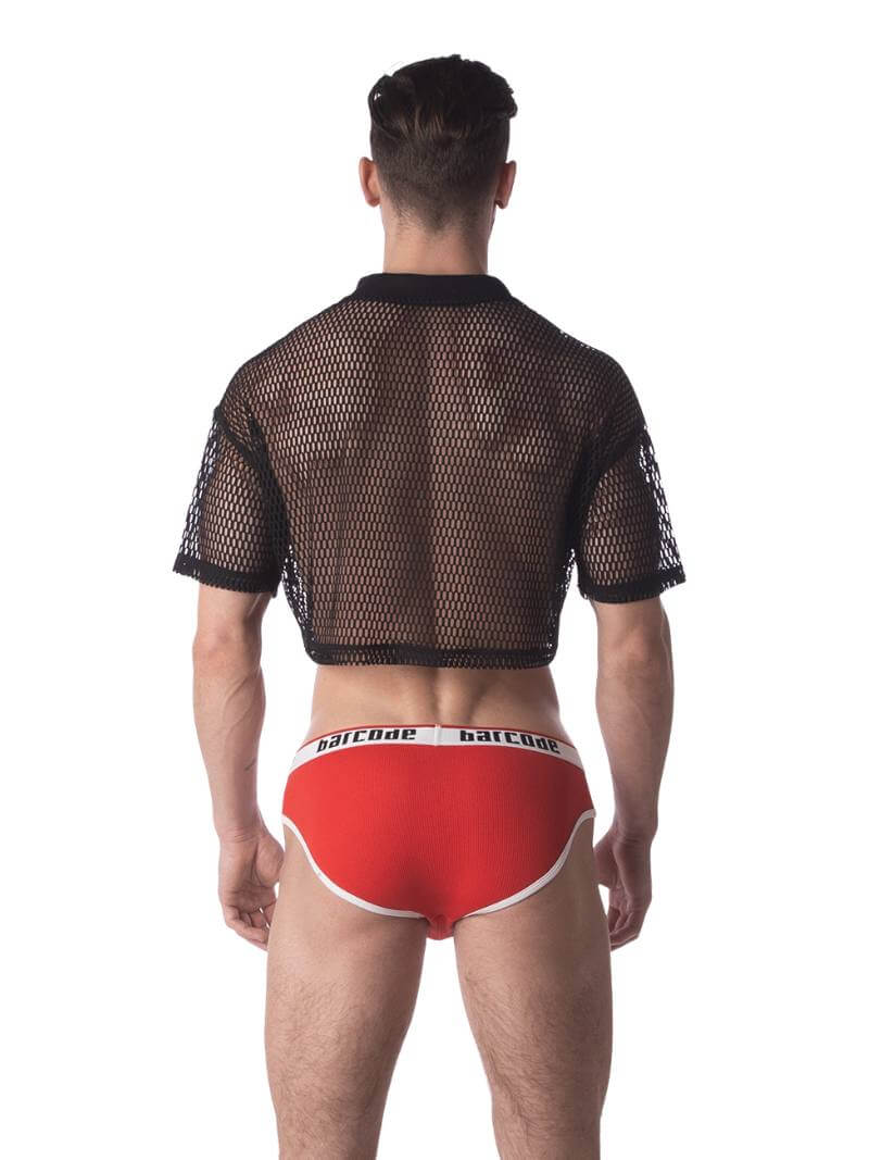 A male model wearing a black semi-see-through mesh fishnet crop top with short sleeves and a v-neck, branded with 'BARCODE'.