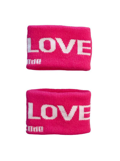 A hand holding two white wristbands with gay pride stripes
