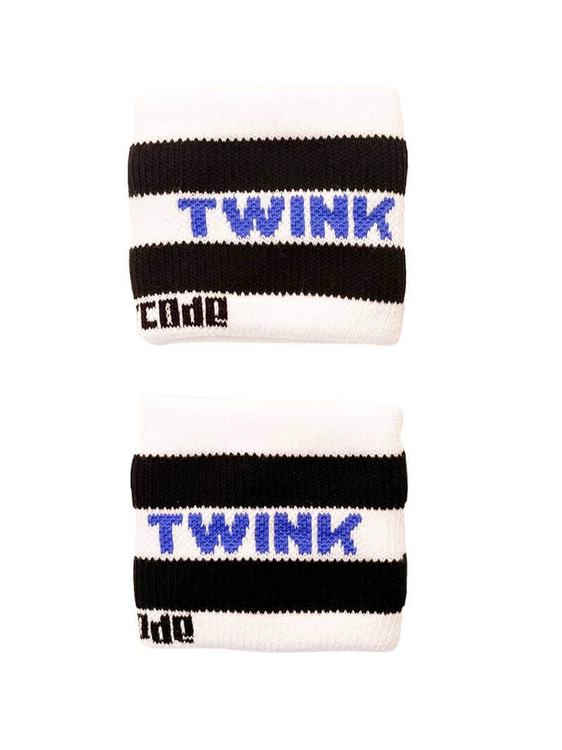 A hand holding two white wristbands with gay pride stripes