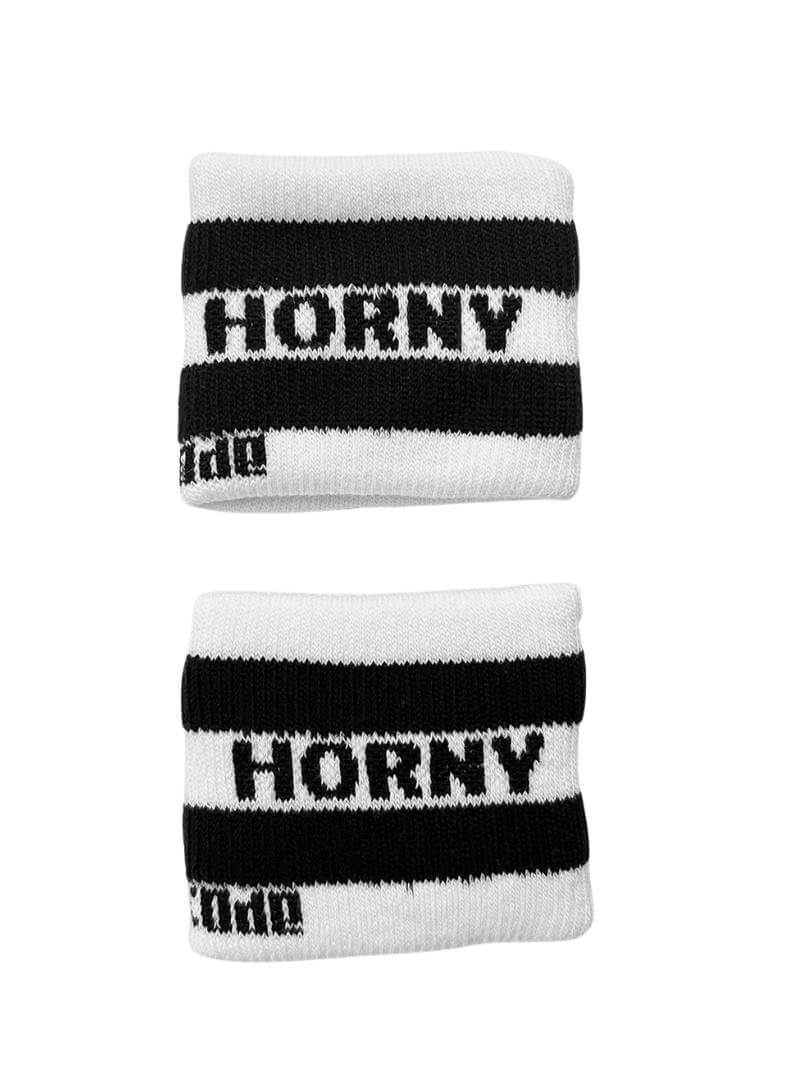 A hand holding two white wristbands with gay pride stripes