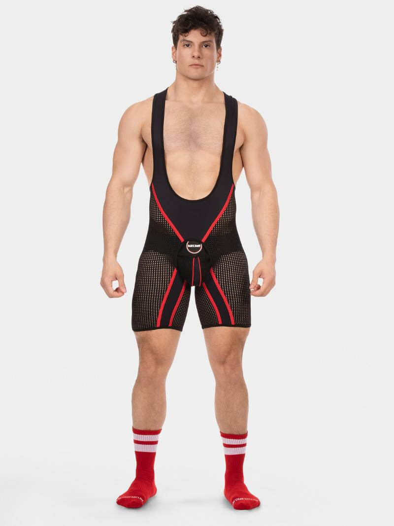 Man wearing a black and red wrestling singlet on a white background