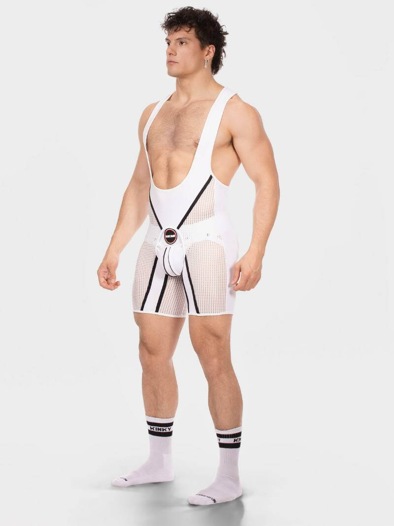 Man wearing a white unitard with suspenders on a plain background