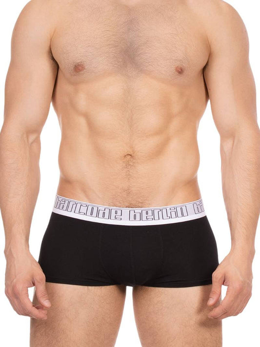 Man wearing black boxer briefs with a brand logo on the waistband against a white background