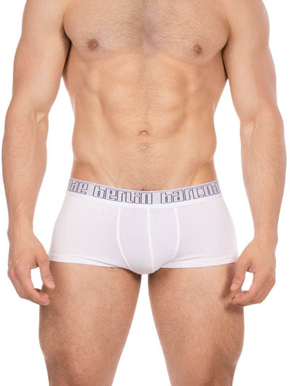 Man wearing white boxer briefs with a brand logo on the waistband against a white background