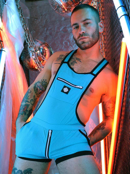 Man wearing a blue athletic outfit with a logo in a neon-lit setting