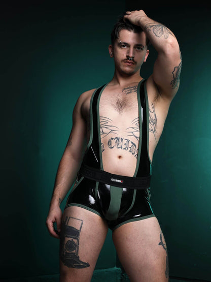 Man wearing a black latex outfit against a dark green background