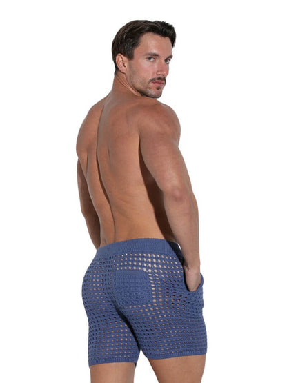 Man wearing blue swim shorts on a white background