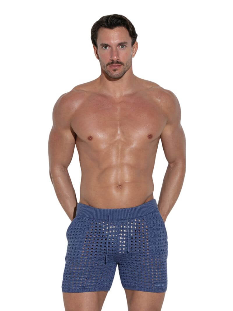 Man wearing blue knitted boxer shorts on a white background
