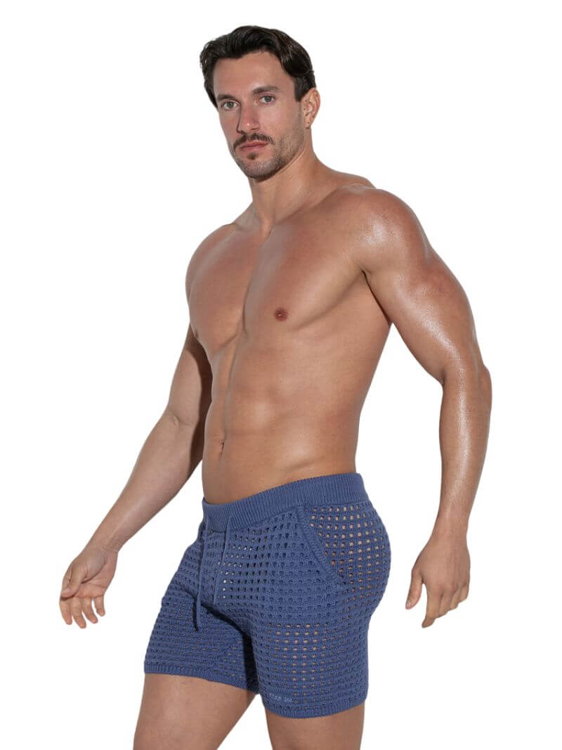 Man wearing blue boxer briefs on a white background