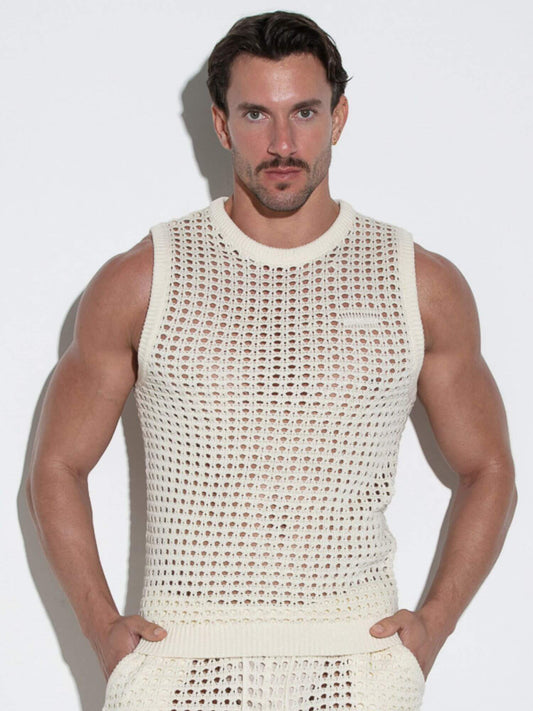 Man wearing a beige sleeveless crochet top against a white background