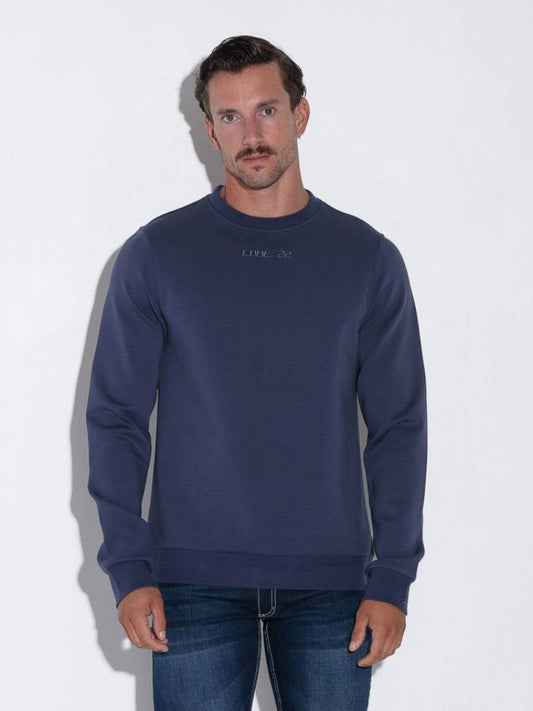 Man wearing a navy blue sweatshirt against a white background