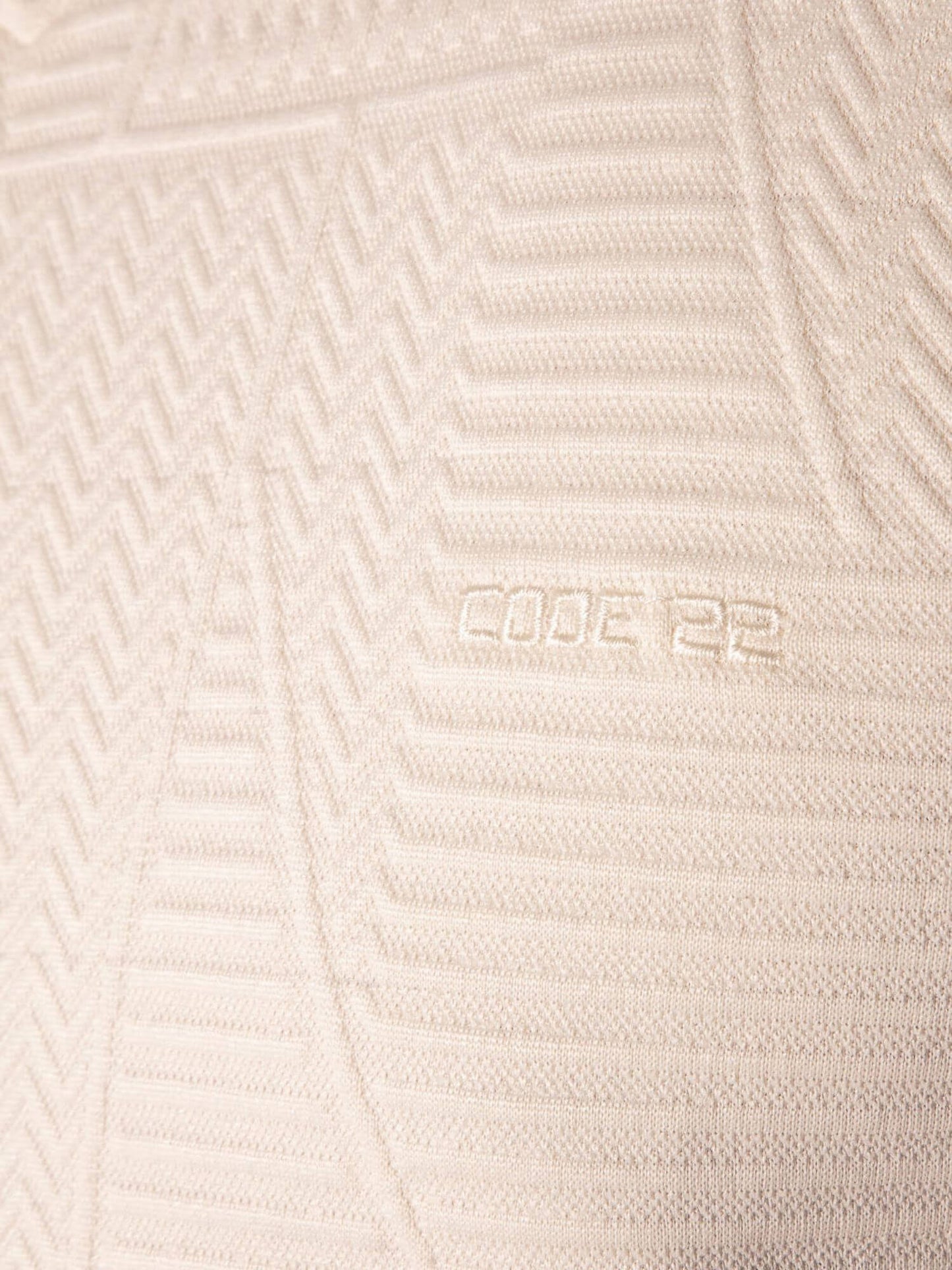 Close-up of a textured beige fabric with 'CODE 22' branding.