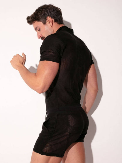 Man wearing a black outfit against a white background